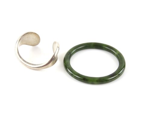 Two items, including, a Tiffany and Co bangle, in silver, made in Spain, and a nephrite jade bangle. Condition Report:  Silve