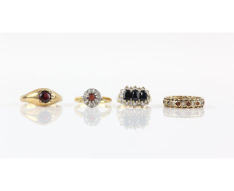 Four rings, one 1970's garnet and diamond set cluster ring, mounted in 18 ct yellow gold, ring size M, another sapphire and p