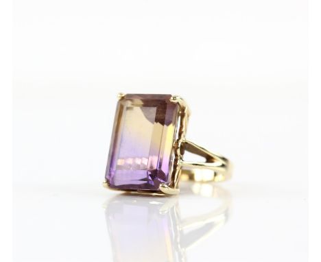 Ametrine ring, featuring a rectangular step cut ametrine, estimated weight 13.09 carats, in a four claw setting, in 9 ct yell