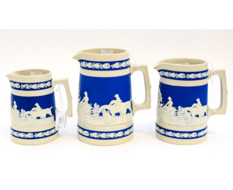A graduated set of three Copeland jugs, circa 1884 with applied hunting scenes, horses, hounds, etc (middle jug has chip to l