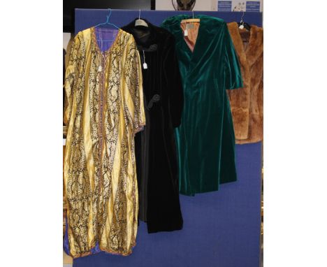 A collection of assorted vintage textiles to include a green velvet coat, black velvet coat, fur stole, fur coat and Moroccan