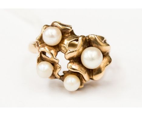 A 9ct gold and pearl dress ring of organic form, set with four pearls, size K, with a total gross weight of approx 4.3gms