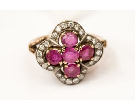 A Victorian ruby and diamond cluster ring, comprising a cross of five round rubies with a grain set edge of diamonds, with a 