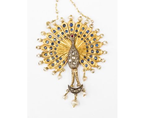 A Victorian peacock pendant, set in yellow gold metal, most likely 15ct, with blue sapphires to the wings, seed pearls to the