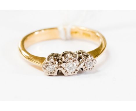 An 18ct gold, three stone diamond dress ring, illusion set approx 3.1gms, ring size K 1/2, with a total gross weight approx 3