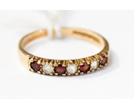 A 9ct gold half eternity ring, claw set with alternate garnets and white stones, size M, total gross weight approx 1.7gms