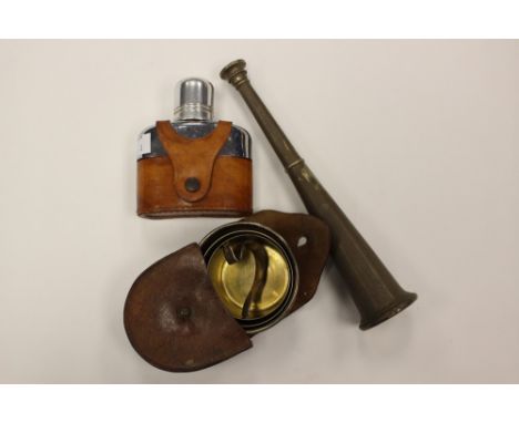 An early 20th century EPNS hunting horn spirit flask, and a cased Goldsmiths retractable beaker and a hip flask in a leather 