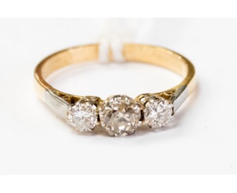 An 18ct yellow gold and diamond three stone ring, central diamond weighing approx .40 ct and two other diamonds weighing comb