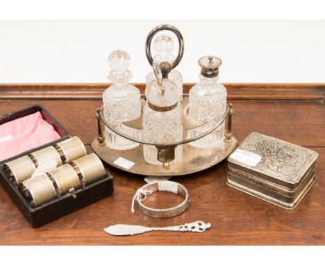 A boxed set of silver plated napkin rings in leather case, a Mappin & Webb silver plated cruet island with cut glass bottles,