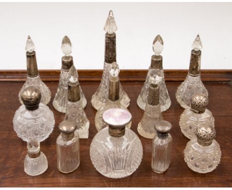 A collection of fifteen silver topped cut glass scent bottles, mostly early 20th Century and later, of various assay offices,