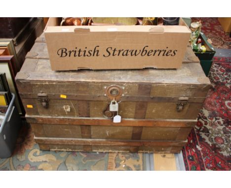 A 20th Century travelling trunk, wood bound and fitted with a leather carrying handle