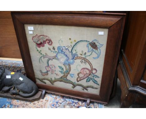 An early 20th century, wood embroidered fire screen