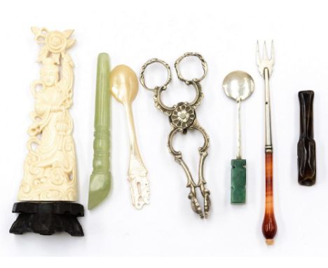 A collection of utensils including ivory ornamenT, cast silver Rococo tea tongs, jade pipe, hardstone handled pickle fork, Ch