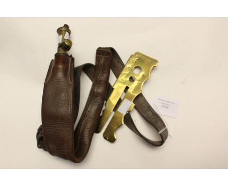 A brown leather and brass Irish pattern shot flask bandoleer and shot along with a WW1 brass button stick (Patent No.116972/1