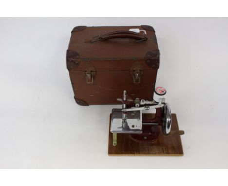 A child's miniature sewing machine, 'Essex' circa 1940, complete with instruction manual, with original case and clamps 