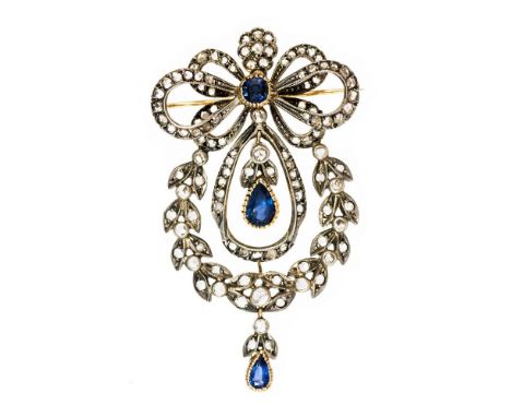 A diamond and sapphire pendant brooch, the garland style openwork bow and wreath set with rose cut diamonds, with two pear sh