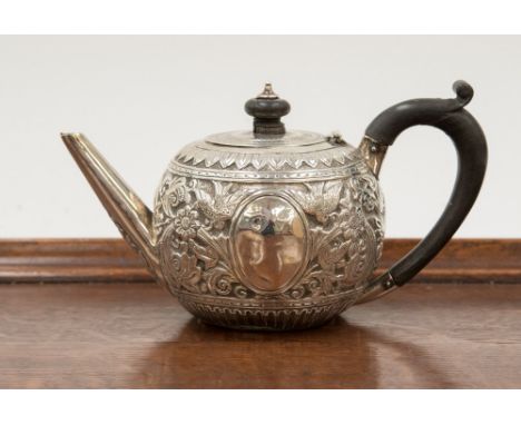 A silver Goldsmiths London silver teapot, London 1887, having raised floral decoration throughout, ebony handle and finial, t