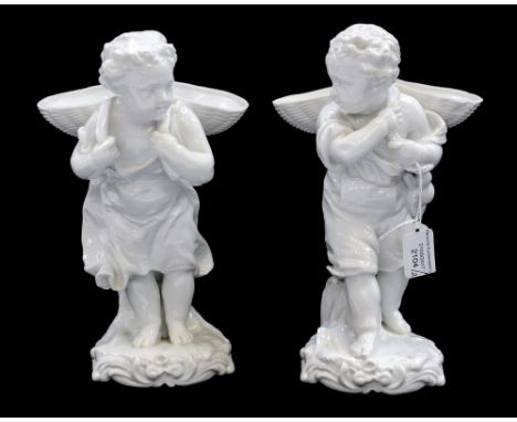 A pair of French hardpaste white glazed figures carrying baskets, with anchor marks s/d