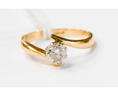 A diamond solitaire 18ct gold crossover ring, the round brilliant claw set diamond approx 0.50 carat, ring size M½, gross wei
