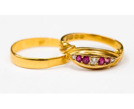 A ruby and diamond 18ct gold ring, set with four rubies and three old cut diamonds, size N,  along with a 22ct gold band size