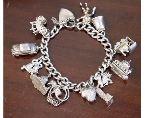 One silver charm bracelet with fourteen trinkets (inc lock)