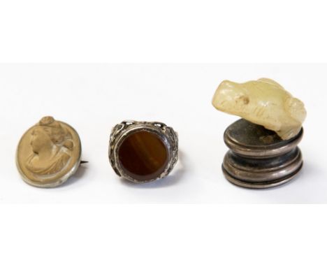 A carved jade and white metal seal, in the form of a frog set with glass eyes; together with a cameo type brooch and a silver