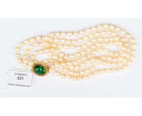 A double row string of cultured pearls with 14k textured gold and jade clasp, approx 65cms