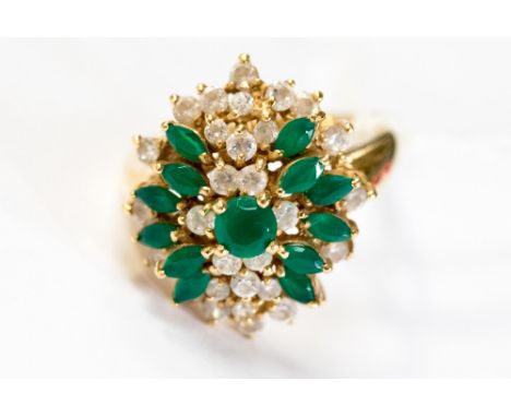 An 18ct gold, green and white stone cluster ring, circa 1960's, floral setting, the setting is approx 2cm x1.7cm, finger size