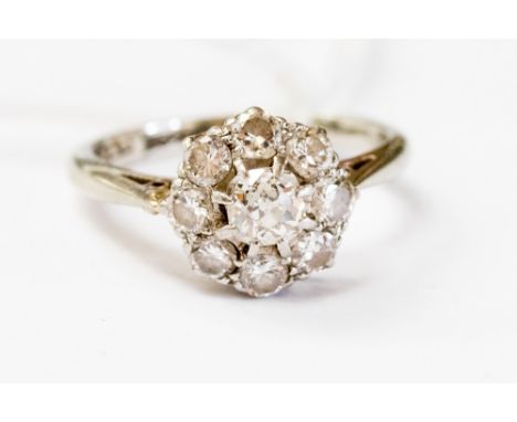 A diamond cluster ring, claw set central cushion cut diamond of approx 0.2 ct, total diamond weight approx 0.5ct, size H1/2 w