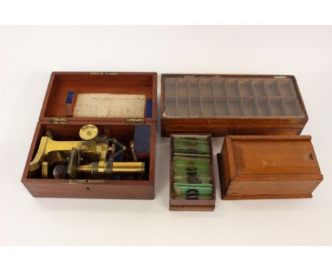 A cased brass microscope by International manufacturer M. Pillischer London, No. 3099, with three loose parts within the case