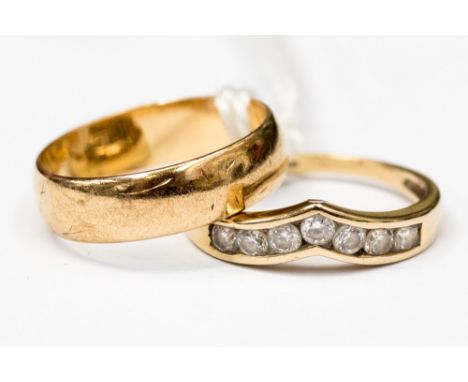 A 9ct gold band, size K, along with a white stone channel set wishbone ring, size I1/2, with a combined total gross weight 3.