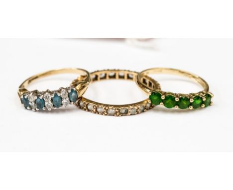 Three 9ct gold rings including a blue and white stone ring, a white stone full eternity ring and a tsavorite garnet, combined