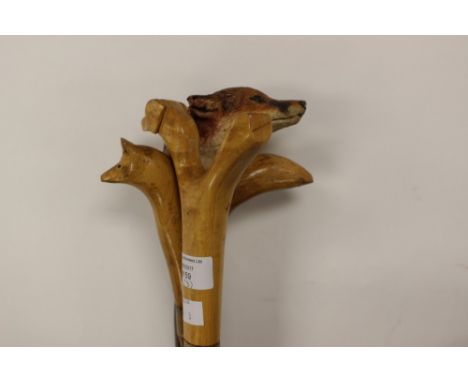 Three walking sticks: two thumbsticks with Dog's head design and one with Fox's head design; one Fox head stick. (3)