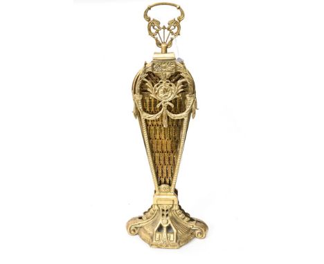 A brass fire screen opening up to a fan shape 