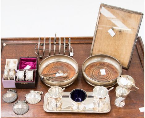 A pair of Victorian silver napkin rings, in case, Sheffield 1896, a silver rectangular photograph frame with wooden easel sup