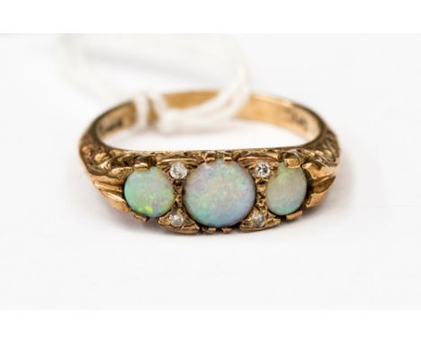 A 9ct gold, opal and diamond boat style ring, set with three round opals with diamonds set in between, size N, approx total w