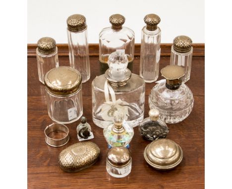 A collection of silver and scent bottles, dressing table bottles and a hip flask, some with silver lids and components, some 