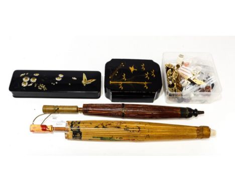 A hand decorated bone belt with a lacquerware glaze box and a lacquerware trinket box, two parasols, and a box of buttons 