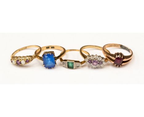 A group of five 9ct gold dress rings, comprising an emerald and diamond set ring, an amethyst and opal boat ring a garnet sin