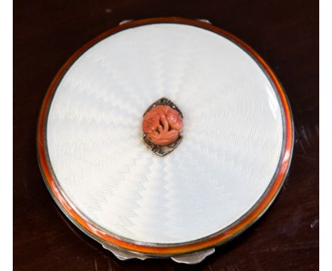 A silver Goldsmiths and Silversmiths powder compact, enamelled and engine turned cover, set with marcasite and carved coral f