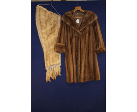 A 1950s vintage Mink fur mid length coat in light brown; together with a blonde Mink fur stole with detachable tassels, good 