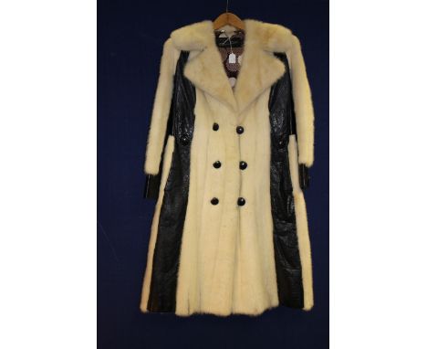 A white Mink coat trimmed with black leather, coat size small 