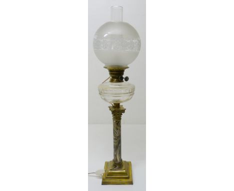 British-made oil lamp, c. early 20th century, with glass reservoir above a Corinthian-type brass mount and cylindrical mottle