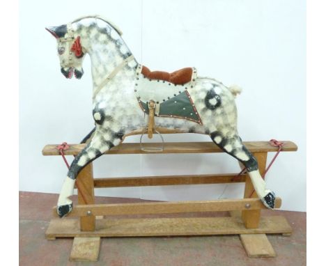 Dapple grey painted rocking horse in the manner of Haddon, with horse hair mane, fixed to a wooden cradle, with stirrups, 111