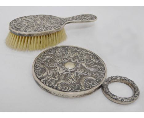 Chinese silver export hand mirror with ring handle (late Qing dynasty), decorated with embossed dragons chasing the flaming p