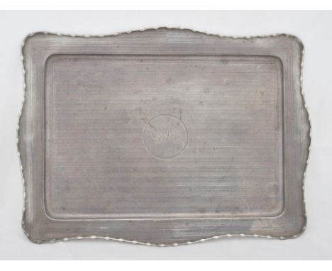 Silver engine-turned shaped toilet tray with central engraved monogram, 30cm x 22cm, 283g.