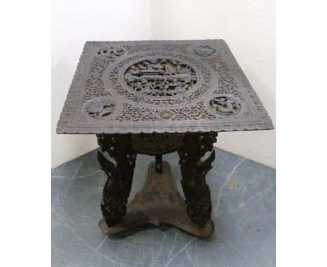 Burmese carved hardwood table, c. early 20th century, the detachable square-shaped top with a central carving of deities and 