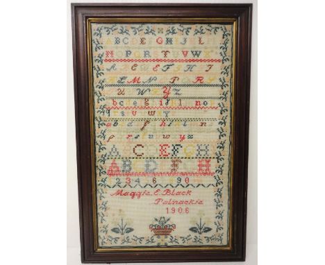 Edwardian needlepoint sampler, worked by Maggie E Black, Palnackie 1906, with stitched alphabets above, later framed and glaz