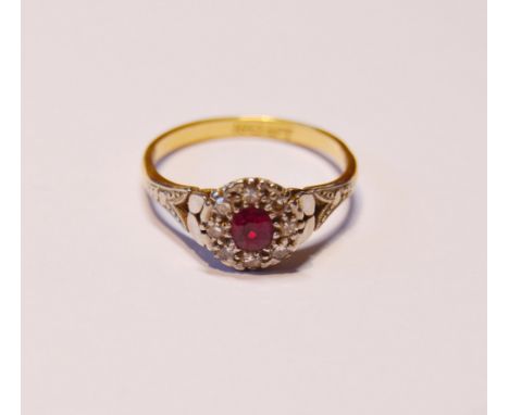 18ct gold ruby and diamond lady's cluster ring in a flowerhead setting with central small ruby, flanked by small brilliants, 