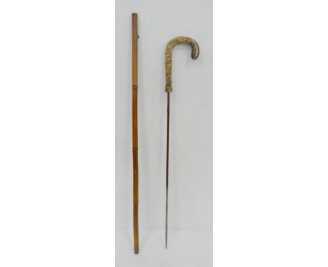Bamboo sword stick, c. early 20th century, with snakeskin-style handle, push button release to the scabbard to reveal sword s